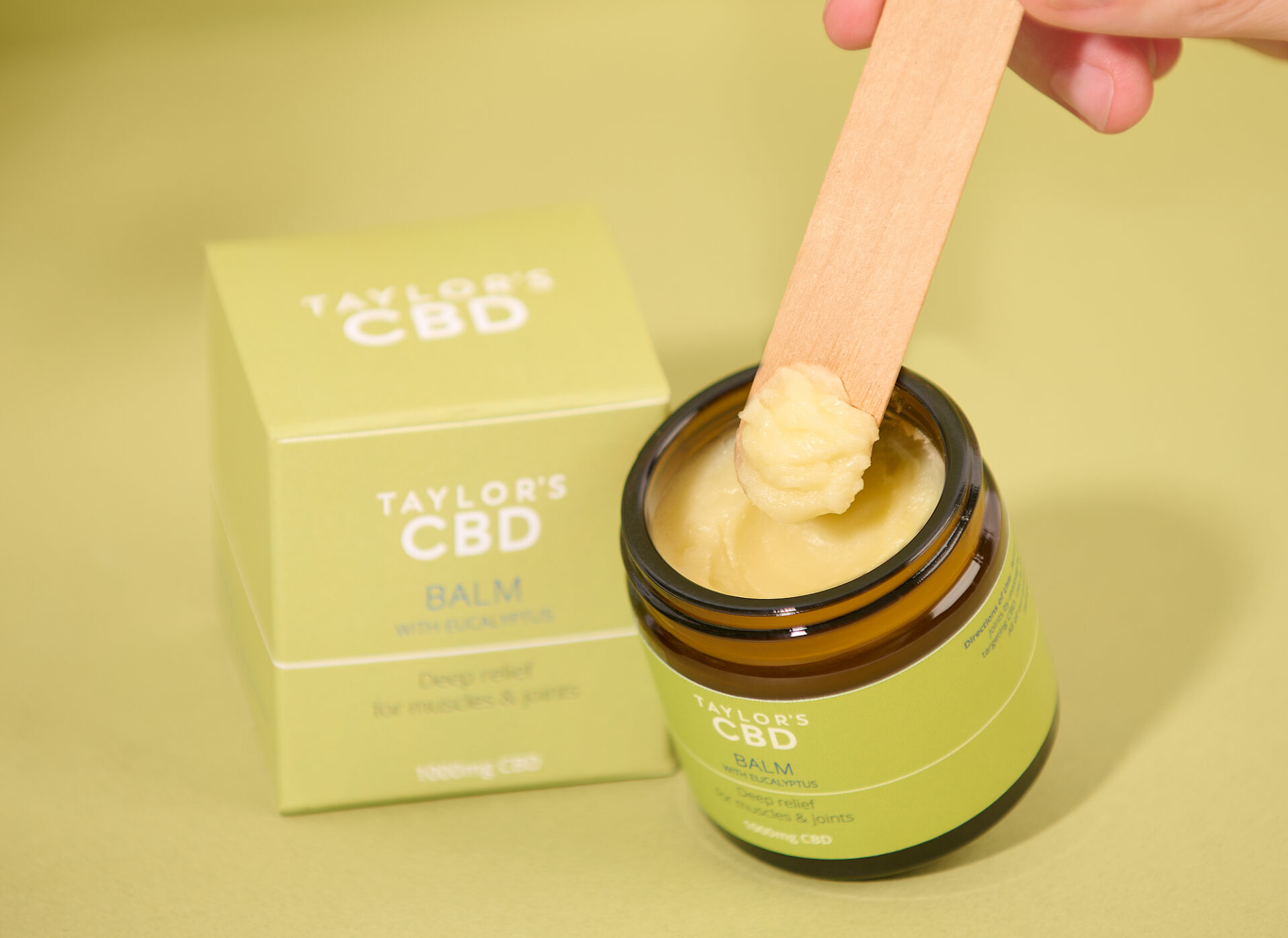 Balm applied on a wooden stick, clearly showing the texture of the product.
